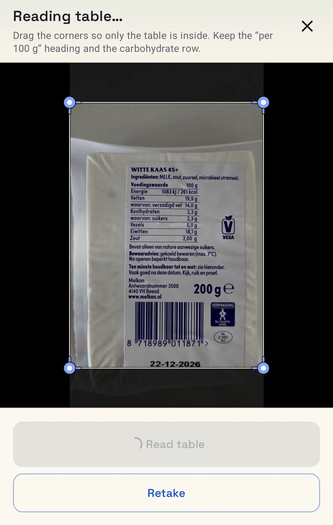 The app reading the nutrition table from a photo of a cheese packet, with corner handles around the table.
